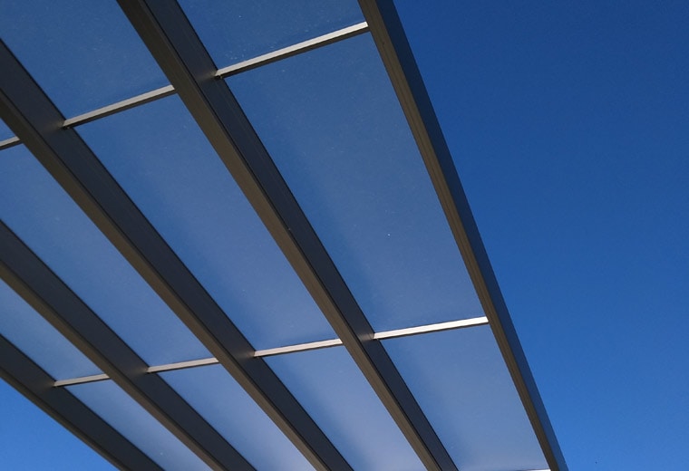 Specifications View through a Commercial Shade with Ao smoke polycarbonate sheets and bronze beams
