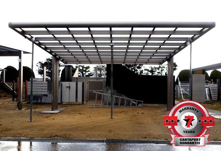 Image of wide beam carport install underway with warranty 7 year guarentee logo